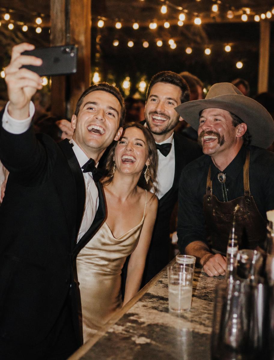 Guests taking a selfie with the cowboy bartender
